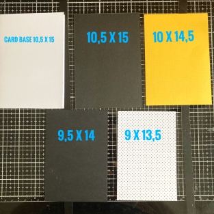 
"Image displaying the layered construction of the card. From bottom to top: a white base card measuring 10.5 centimeters by 15 centimeters; a yellow cardstock mat measuring 10 centimeters by 14.5 centimeters; a black cardstock layer measuring 9.5 centimeters by 14 centimeters; and a patterned paper with black dots measuring 9 centimeters by 13.5 centimeters. Each layer adds depth and dimension to the overall design.